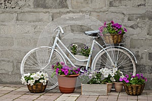 Vintage white bicycle on a background of a concrete wall