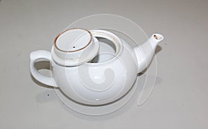 A vintage white ceramic teapot isolated on white background