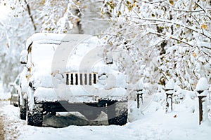 Vintage white Jeep is parked in a picturesque wintery landscape