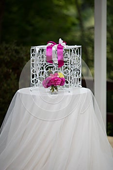 Vintage white ornated metal cage at wedding aisle with flowers i