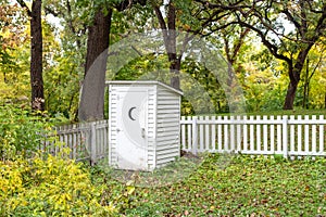 Vintage White Outhouse in Rural United States