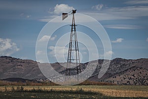 Vintage Windmill Stands in Rural Field