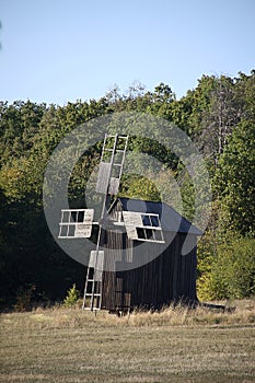 Vintage windmill wooden mill with wind wheel blades