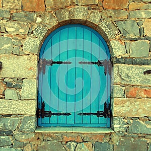 Vintage window with blue close shutters, Crete, Greece.