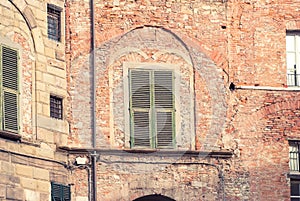 Vintage window with green shutters