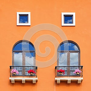 Vintage window on orange cement wall.