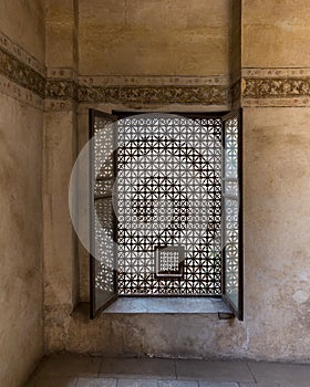 Vintage window with wooden arabesque ornaments - Mashrabiya - and grunge stone wall photo