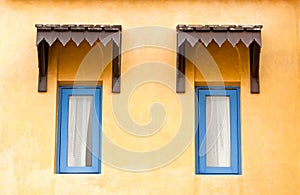 Vintage window on yellow cement wall