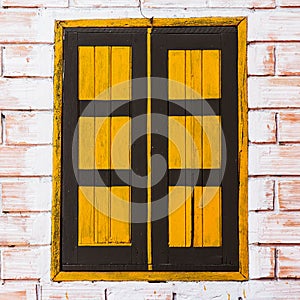 Vintage window on yellow cement wall