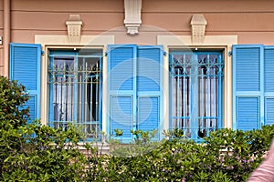 Vintage windows with blue shutters in old house, Provence, Franc