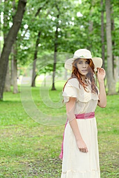 Vintage woman wearing a hat in park setting