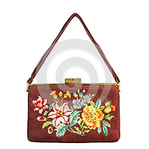 Vintage women`s bag with an embroidered pattern of flowers. Isolated on a white background