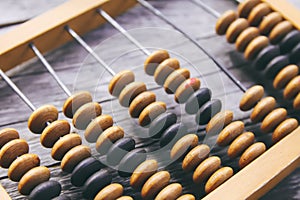 Vintage wooden abacus on old board.