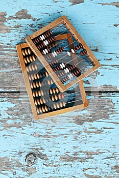 Vintage wooden abacus on old board surface.