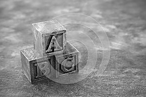 Vintage wooden alphabet blocks on dark background