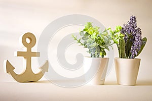 Vintage wooden anchor with purple lavender and tree in pot background