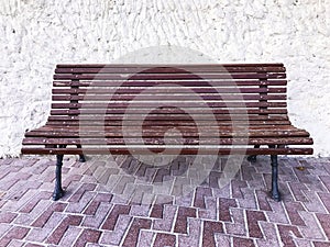 Vintage wooden bench on stone background