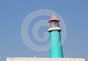 Vintage, wooden blue and pink lighthouse.