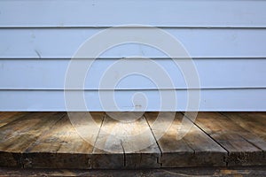 vintage wooden board table in front of old wooden background. Ready for product display montages