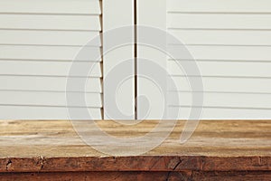 vintage wooden board table in front of old wooden background. Ready for product display montages