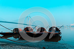 Vintage wooden boat on ganga river near hoogly bridge