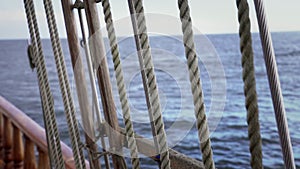 Vintage wooden boat pulley and ropes detail Shrouds and ropes of an old sailboat