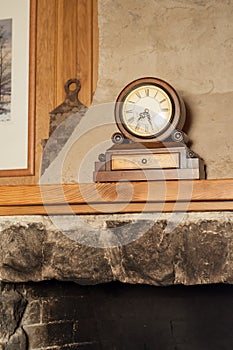 Vintage wooden clock on the mantelpiece