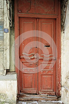 Vintage wooden door painted red with letterbox hole