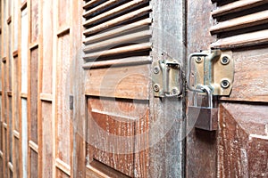 Vintage wooden door texture background with old steel lock is lo