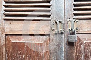 Vintage wooden door texture background with old steel lock is lo