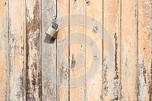 Vintage wooden door texture background with old steel lock.