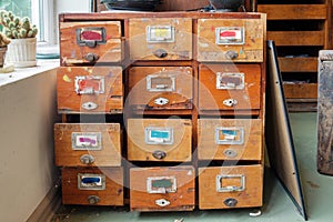 Vintage wooden drawers with colorful empty tags