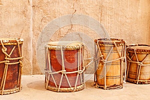Vintage wooden drums over old wall background. Traditional mediterranean musical instrument