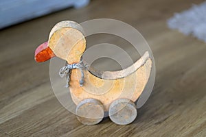 Vintage wooden duck toy on wheels