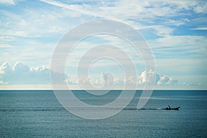 Vintage wooden fishing boat sail in the sea with great sea and sky background