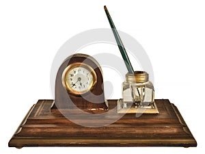 Vintage wooden inkstand with pen, glass ink pot and small clock isolated on white photo