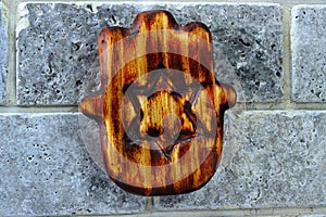 Vintage wooden Jewish Hamsa. Hamsa - Hand shaped amulet for protection in Jewish culture in Israel and world