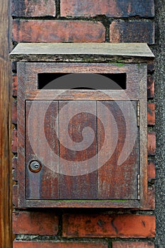 Vintage Wooden Mailbox on the Brick Wall