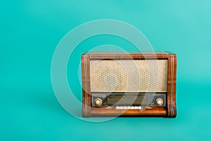 vintage wooden radio receiver on turquoise