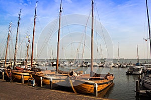 Vintage wooden sailboats docked in a Holland harbor