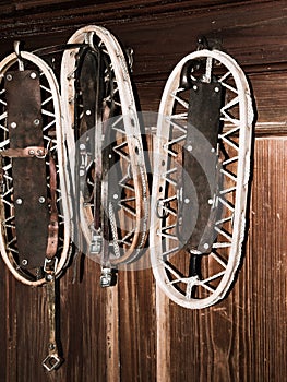 Vintage wooden snowshoes hanging on the wall in mountain cottage photo
