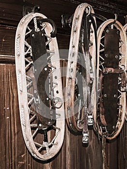 Vintage wooden snowshoes hanging on the wall in mountain cottage photo