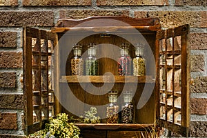 Vintage Wooden Spice Rack or Storage Cabinet and six glass bottles