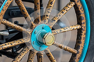 Vintage wooden spoke car wheel. Close-up of wood spokes photo