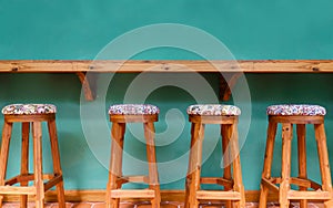 Vintage wooden stool chair on green background