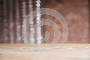 Vintage wooden table with blur brick wall background