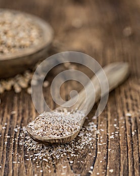 Vintage wooden table with Wheat Bran selective focus; close-up shot