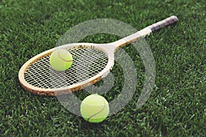 Vintage wooden tennis racket on grass