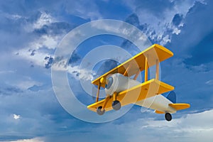 Vintage wooden toy airplane flying on cloudy sky