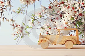 Vintage wooden toy car over wooden table. Nostalgia and simplicity concept.